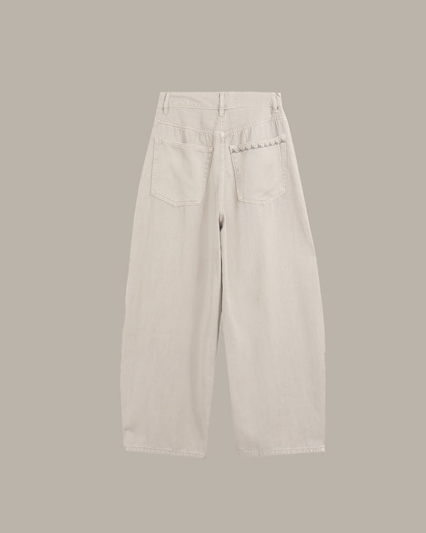 A pair of light beige wide-leg cropped jeans shown from the back, featuring a button closure, belt loops, and two back pockets with decorative stitching, set against a solid taupe background.