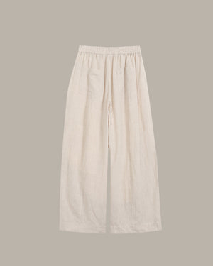 Beige wide-leg pants on a light gray background