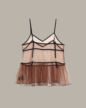 Sheer camisole with brown bottom and black straps on a beige background