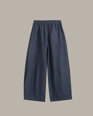 navy wide-leg pants on a light gray background