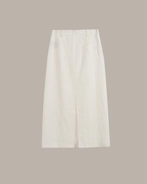 A pair of off-white cropped skirt with a back slit, shown flat against a solid taupe background.