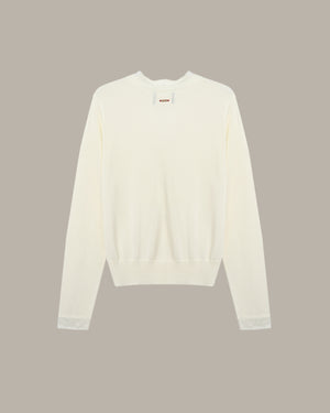 White sweater on a beige background