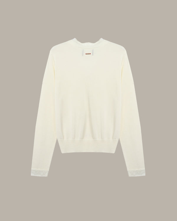 White sweater on a beige background