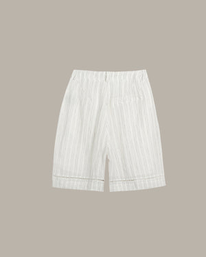 White striped shorts on a beige background