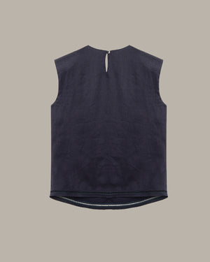Black sleeveless top on a beige background