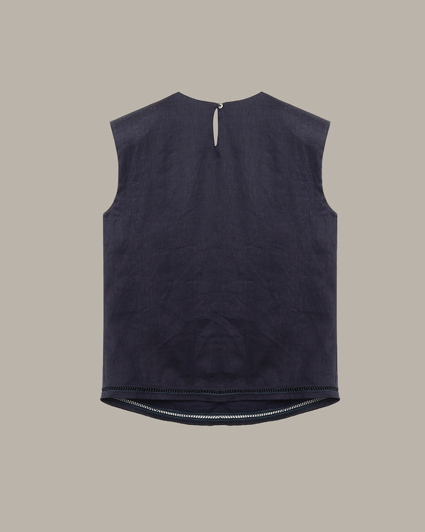 Black sleeveless top on a beige background