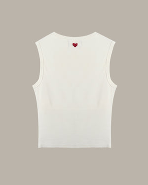 White sleeveless top with a red heart on a beige background