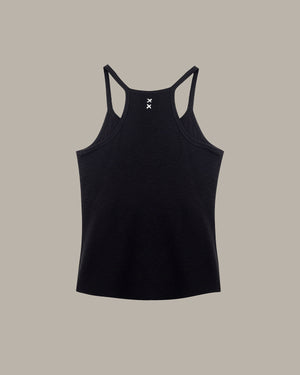 Black tank top with thin straps on a beige background