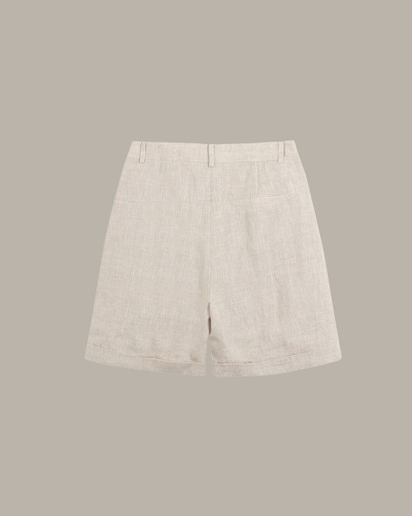 Light beige shorts on a gray background