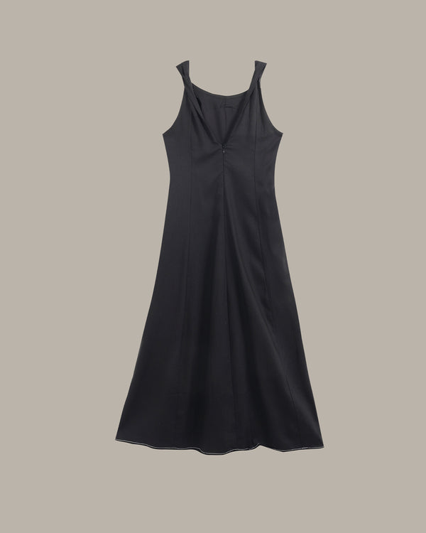 A black sleeveless slip dress with a draped neckline and a gathered front, displayed against a solid taupe background.
