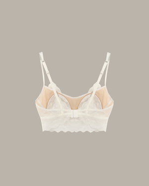 White lace bralette on a beige background