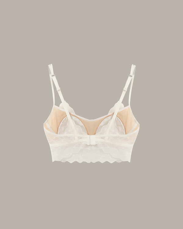 White lace bralette on a beige background