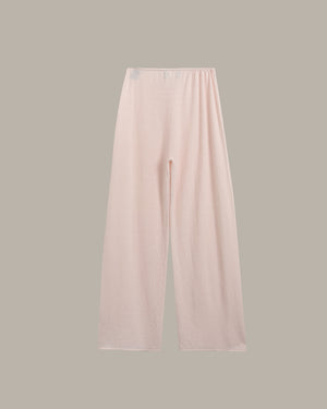 Light pink wide-leg lounge pants with an elastic waistband, shown flat against a solid taupe-gray background.