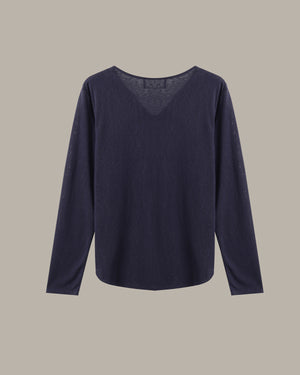 A dark navy blue long-sleeve knit top with a wide boat neckline, displayed flat against a solid taupe background.