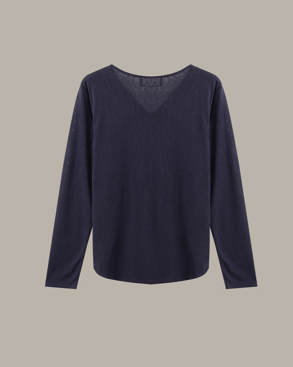 A dark navy blue long-sleeve knit top with a wide boat neckline, displayed flat against a solid taupe background.