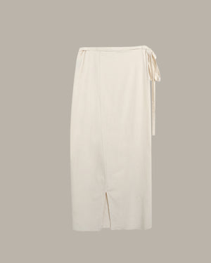 White wrap skirt with a tie detail on a light gray background