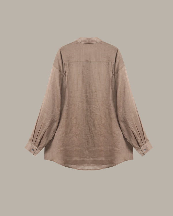 A light brown linen shirt shown from the back, featuring a relaxed fit, long sleeves with buttoned cuffs, and a simple collar, set against a solid taupe background.