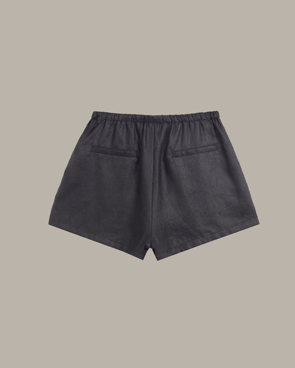 Dark gray shorts on a beige background