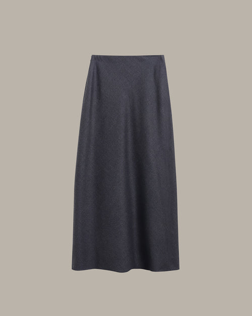 A dark charcoal gray knit midi skirt with a subtle textured pattern, shown flat against a solid taupe-gray background.