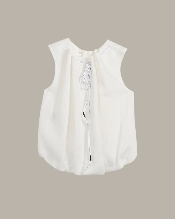 White sleeveless blouse with a zipper on a beige background