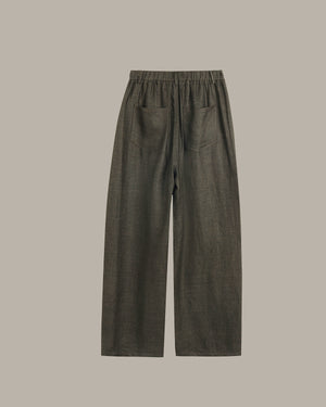 Dark green pants on a beige background
