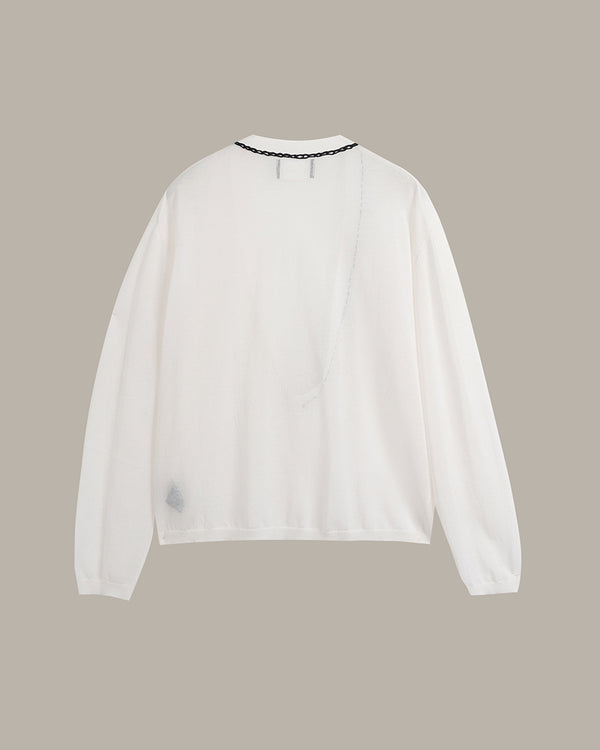 A white long-sleeve top with a crew neck and a delicate black beaded trim, shown from the back against a solid taupe background.
