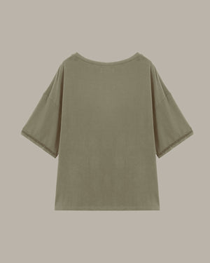 Green t-shirt on a beige background