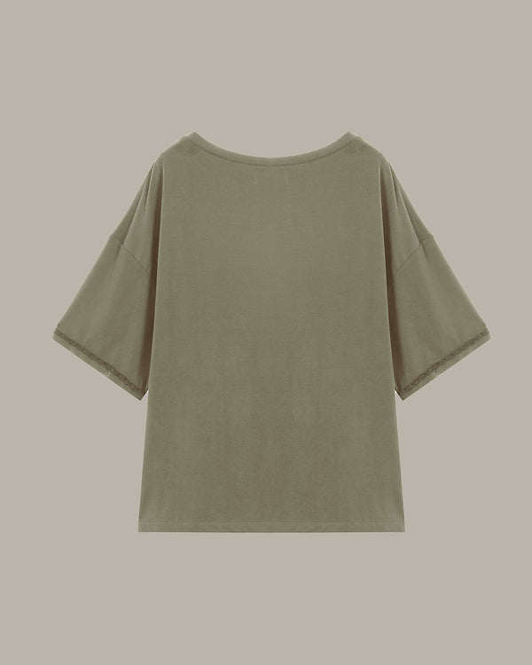 Green t-shirt on a beige background
