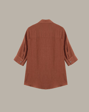 Brown button-up shirt on a beige background