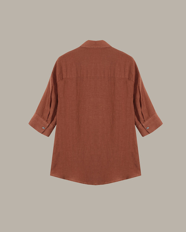 Brown button-up shirt on a beige background