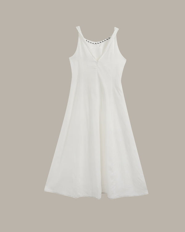 A white sleeveless V-neck dress with a flared skirt, shown against a solid taupe background.