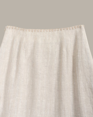 Close-up of a beige fabric with a subtle pattern on a neutral background