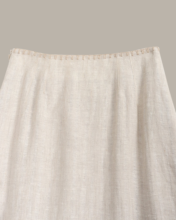 Close-up of a beige fabric with a subtle pattern on a neutral background