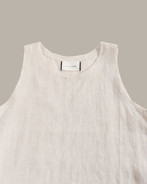 Light beige sleeveless top on a gray background
