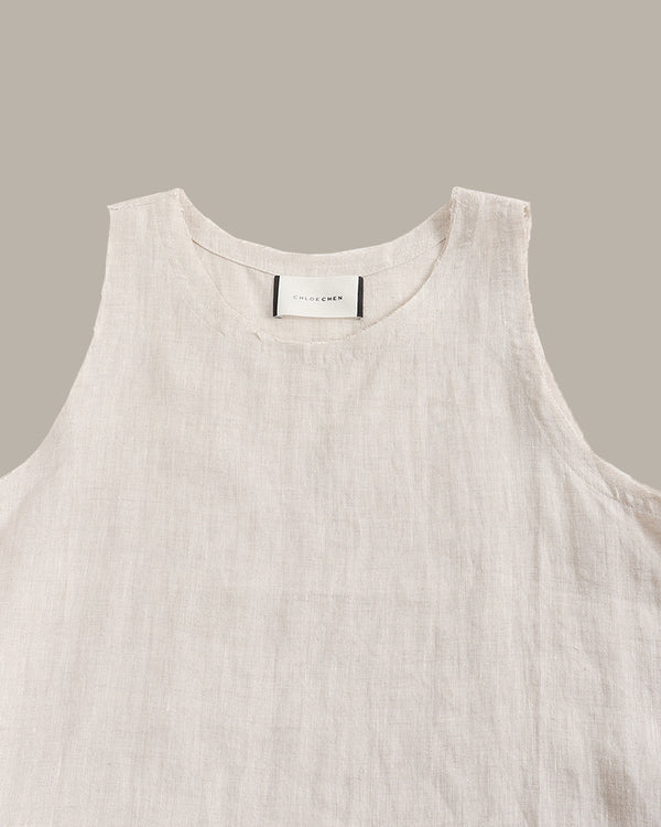 Light beige sleeveless top on a gray background