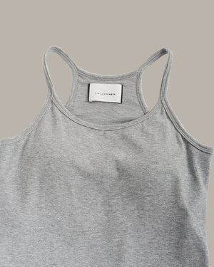 Gray tank top with a visible brand label on a beige background