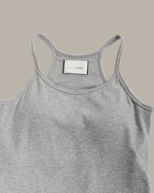 Gray tank top with a visible brand label on a beige background