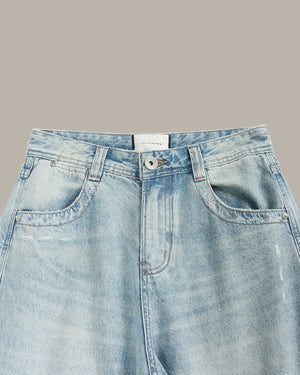 Light blue denim jeans on a gray background