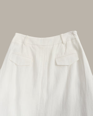 Close-up of a white skirt with a plain background