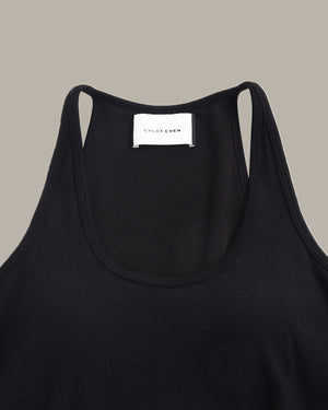 Black tank top with a visible brand label on a neutral background