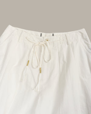 White pants with drawstring on a light gray background