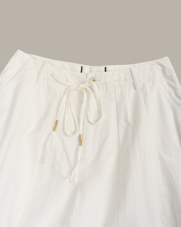White pants with drawstring on a light gray background