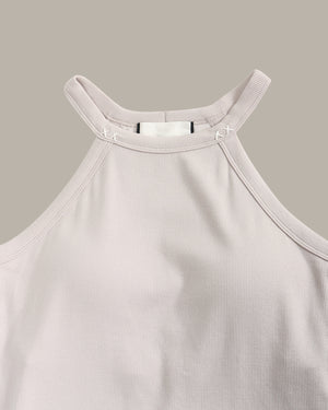 Light pink ribbed tank top on a beige background