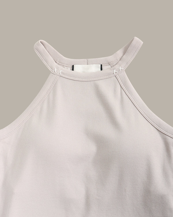 Light pink ribbed tank top on a beige background