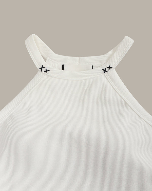 White ribbed tank top with black stitch on the crew neck on a beige background