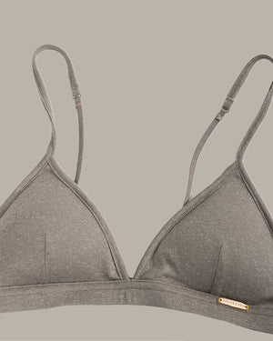Gray bra with thin straps on a beige background