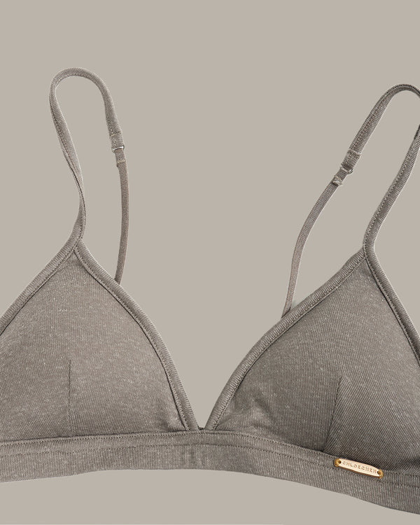 Gray bra with thin straps on a beige background