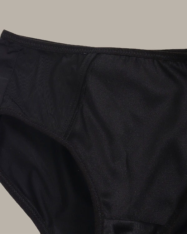 Close-up of black underwear on a neutral background