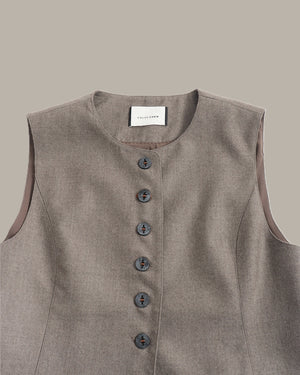 A sleeveless taupe-gray linen vest with a button-down front and a white neck label reading 'CROCHET CLOTHING', shown against a solid taupe background.