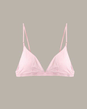 A light pink underwire bra with thin vertical white pinstripes and thin shoulder straps, shown against a solid taupe-gray background.
